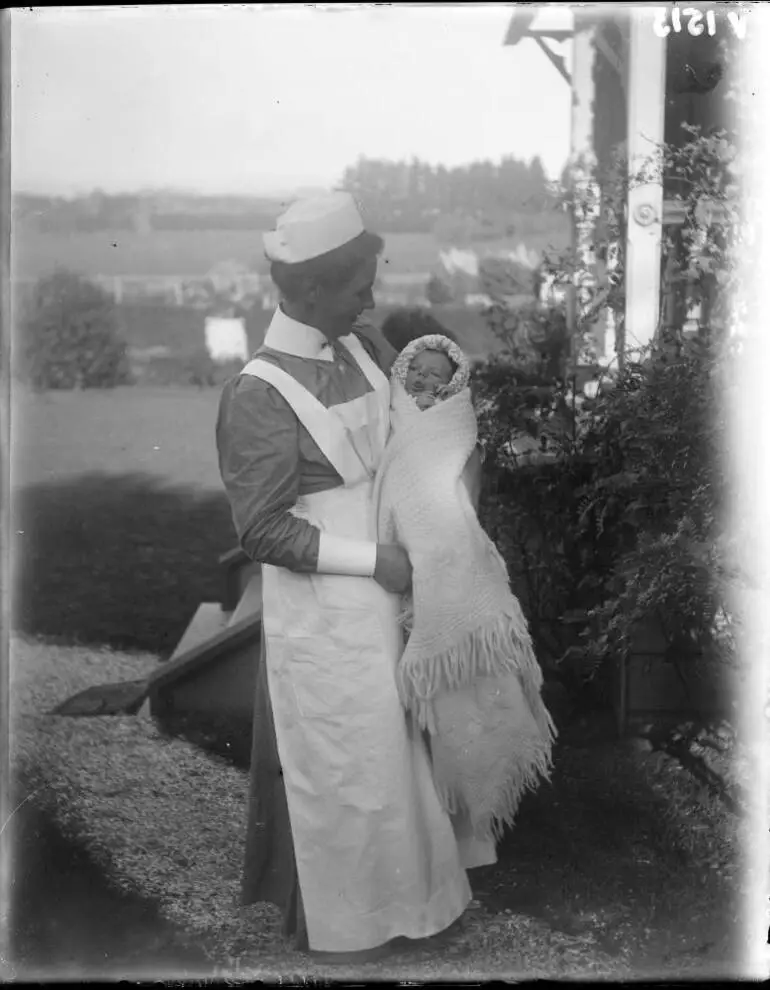 Image: Nurse holding a baby