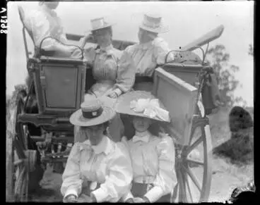 Five women seated in a carriage Image: Five women seated in a carriage