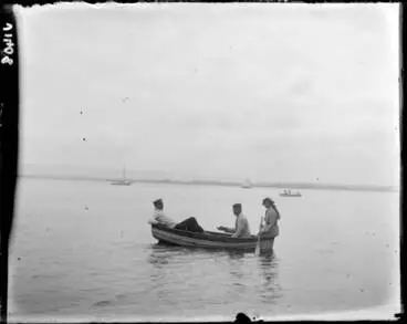 Three people in a dinghy at Kendall Bay, 1910 Image: Three people in a dinghy at Kendall Bay, 1910