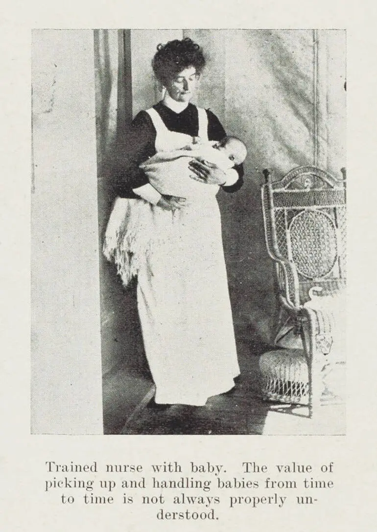 Image: Trained nurse with baby. The value of picking up and handling babies from time to time is not always properly understood