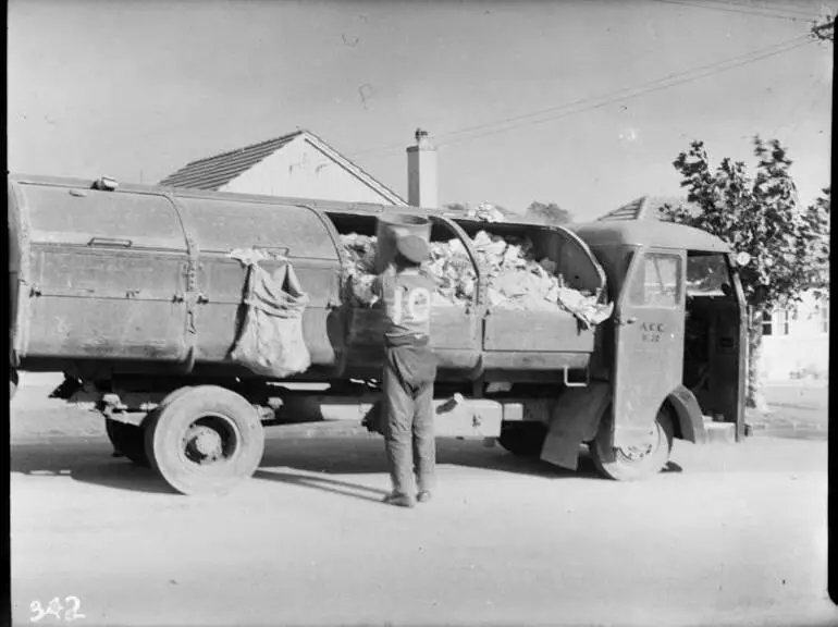 Image: Man loading rubbish onto a rubbish truck, 1949