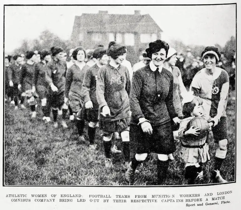 Image: Athletic women of England: football teams from Munition Workers and London Omnibus Company being led out by their respective captains before a match