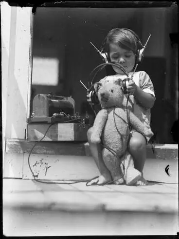 Image: Robert Emirali and his teddy listening to a crystal set, 1928