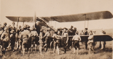 Image: Boy scouts gathered around a bi-plane : Photograph