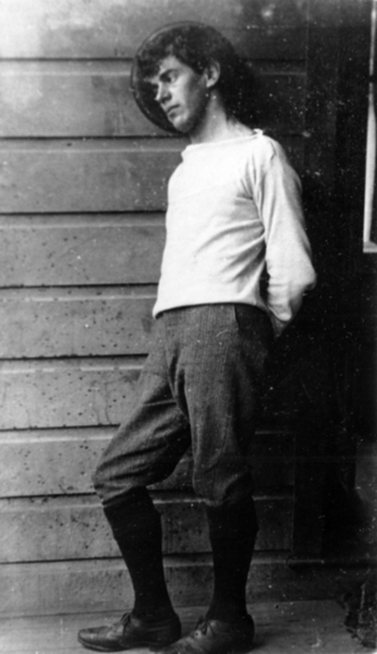 Image: A man leaning against a wall