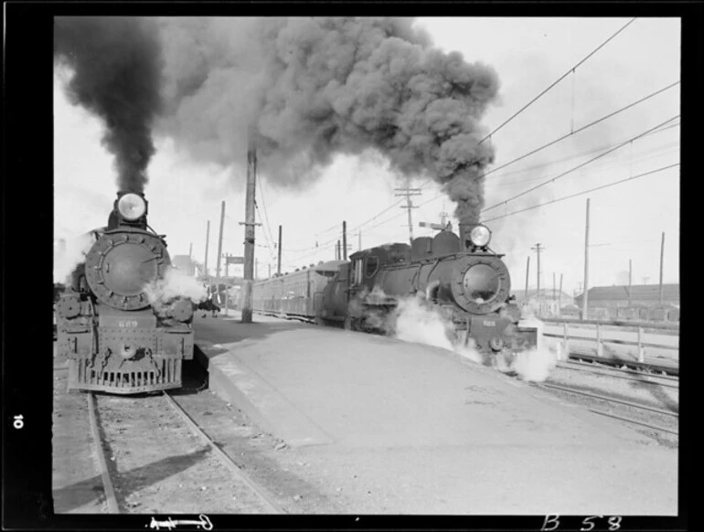 Image: Waipara train streams out of Christchurch station past waiting Ashburton train, 1950