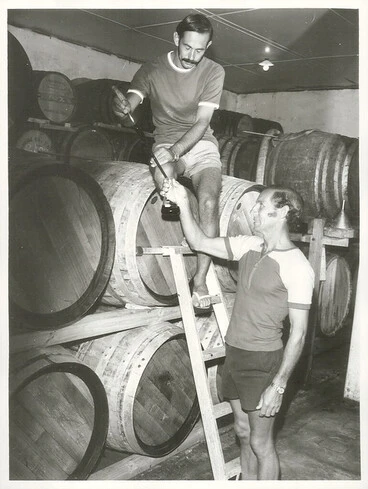 Image: Cabernet Sauvignon maturing in oaken casks in the Babich brothers cellars at Henderson. Joe (above) and Peter Babich take a sample for testing