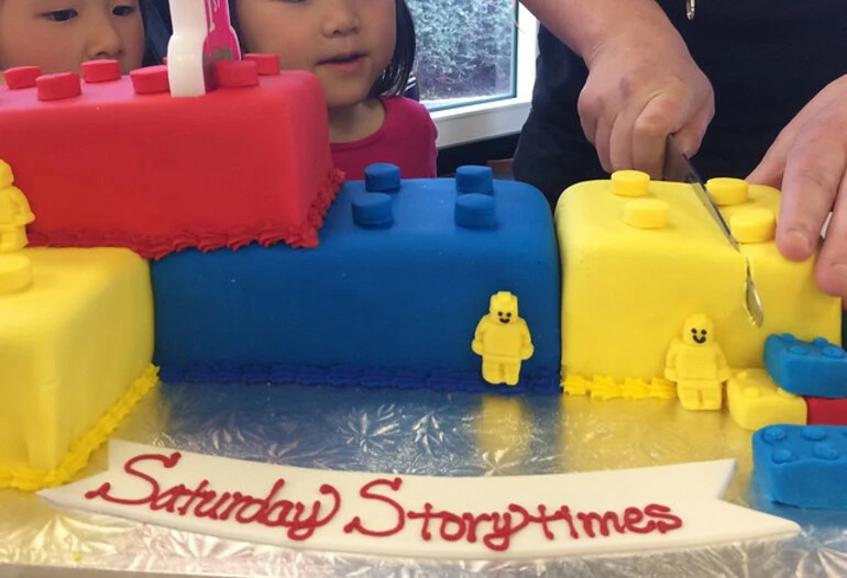 Image: Cutting the Super Saturday Storytimes birthday cake