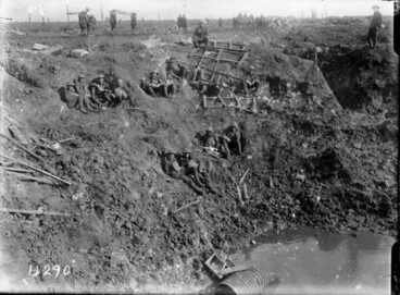 Image: World War I New Zealand Engineers resting in a large shell hole at Spree Farm