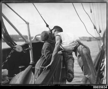 Image: Man and woman kissing across two vessels, 1920-1939