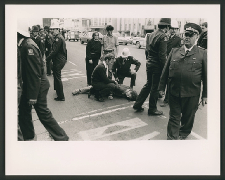 Image: A demonstrator lies bloody unconscious in Victoria St, Hamilton.