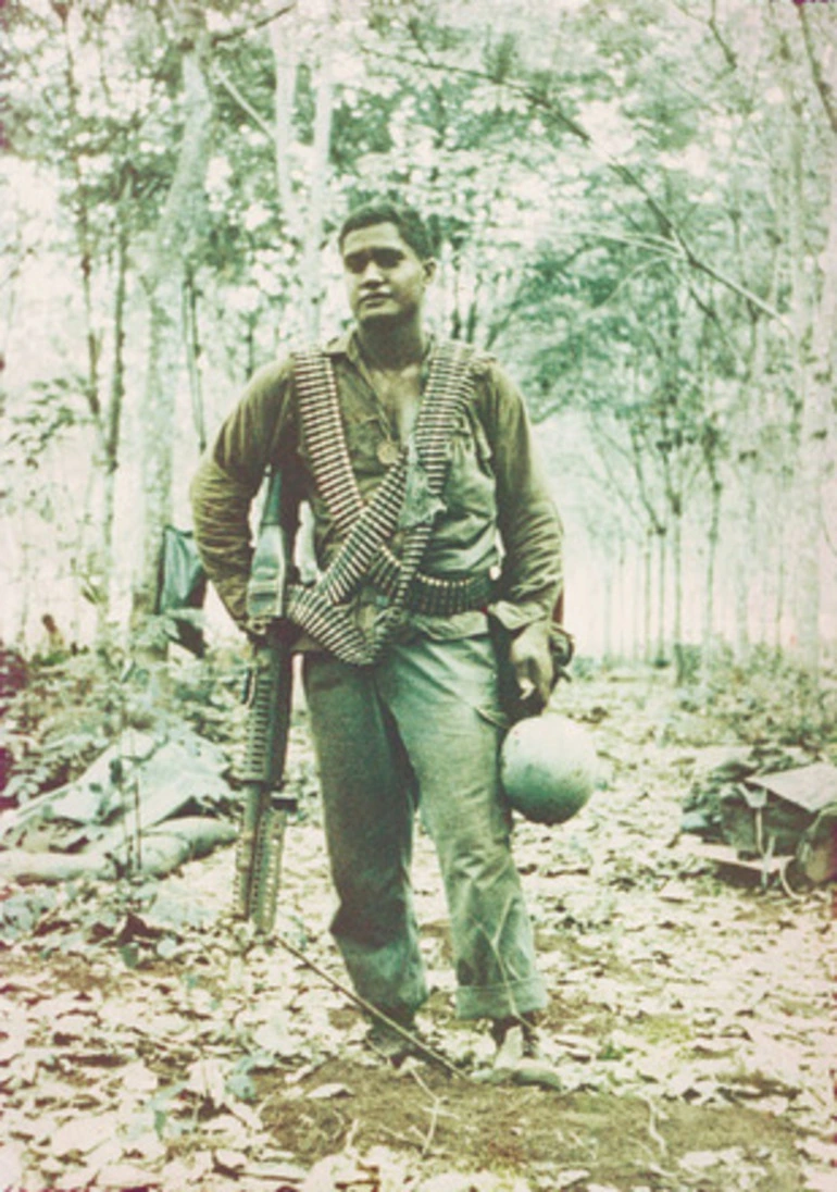 Image: Matua P. Teokoitu in field, holding coconut. Vietnam [copy]