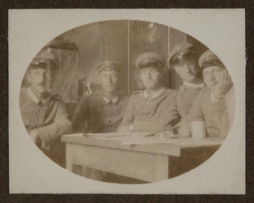 Image: [Soldiers around a table].