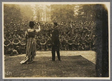 Image: All eyes on the "lady". An open air performance by the Pierrots of a neighbouring division largely attended by N.Z. soldiers.