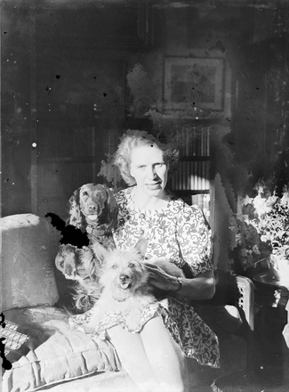 Image: [Portrait of woman holding two dogs]