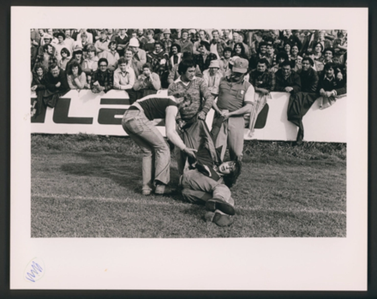 Image: Rugby supporters hand a demonstrator off the Field, Hamilton.