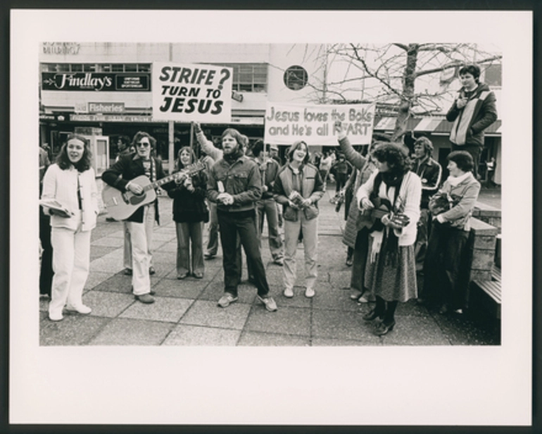 Image: [Christian protesters sing in an outdoor shopping centre]