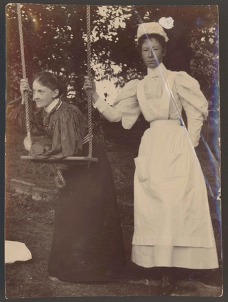 Image: [Nurse Pierce and unidentified nurse leaning/standing beside a swing]