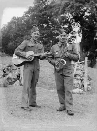 Image: [Portrait of two military servicemen with guitar and saxophone]