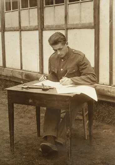 Image: Unidentified WWI soldier with a prosthetic right hand learning to write with his left hand at Oatlands Park, Surrey, England