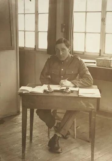 Image: Unidentified WWI soldier, right arm amputated, seated at a desk at Oatlands Park, Surrey, England