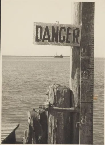 Image: Water height warning sign on pier, England