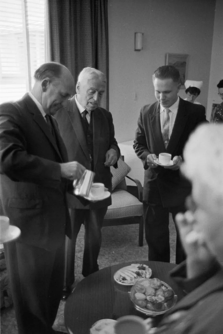 Image: Prime Minister Walter Nash speaks with other men at a function