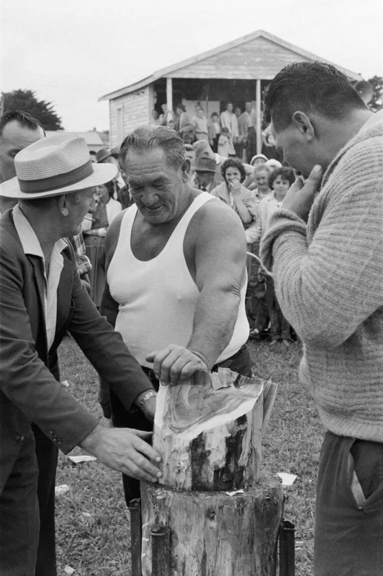 Image: Wood chopping contestant with judges at the Kumeu A & P show