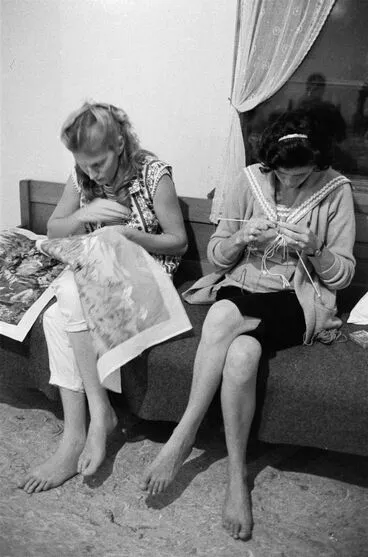 Image: Two women working on their embroidery and knitting
