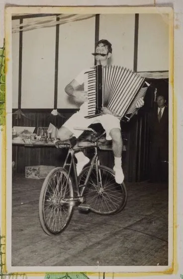 Image: [Clown playing an accordion on a bike]