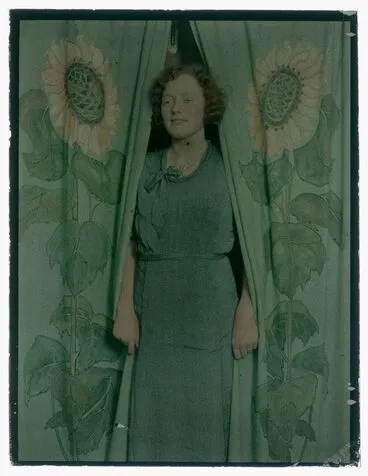 Image: Woman (smiling) with sunflower print curtains