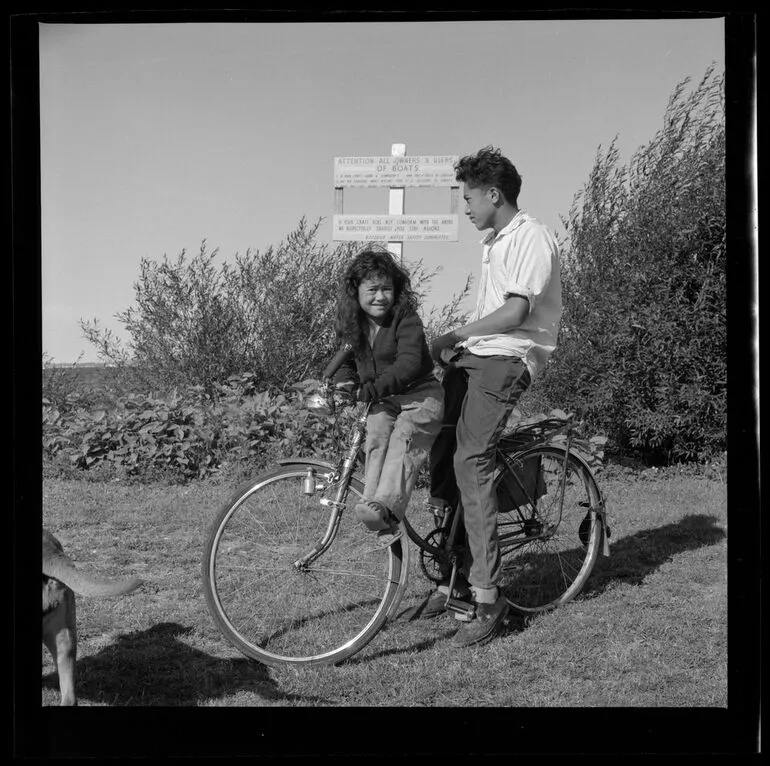 Image: Young man and child on a bicycle