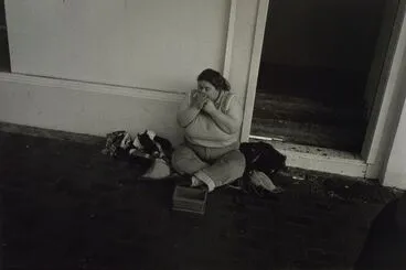 Image: Untitled, no.31 (woman sitting on street playing the harmonica). From the series: Public