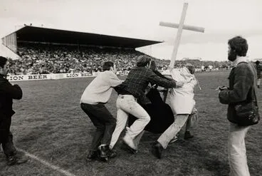 Image: Two members of St John's College run onto Rugby Park, Hamilton, while two supporters of Springbok Rugby Tour try to stop them, 1981