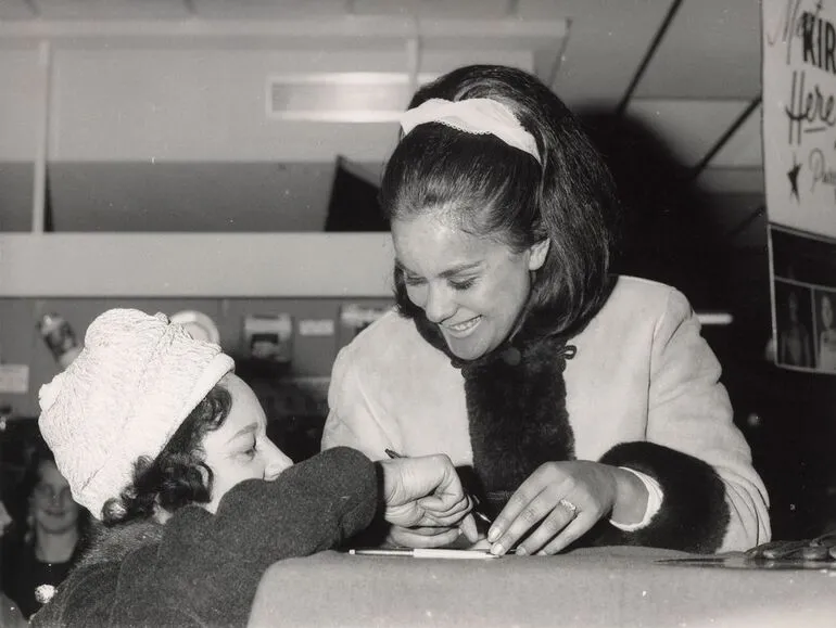 Image: Kiri Te Kanawa signing an autograph