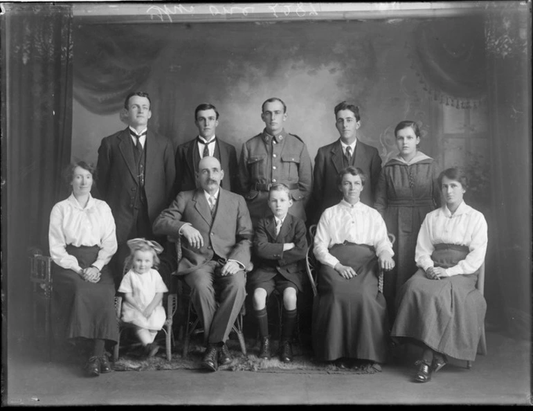 Image: Studio family portrait, unidentified older couple with adult family and grandchildren, with one man in soldier's uniform, Christchurch