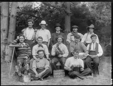 Image: Unidentified group of summer campers, posing for a group portrait, showing one holding a accordion and another holding a brass horn, probably Christchurch district