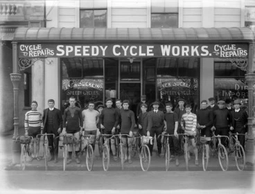 Image: Jack Suckling, and a row of cyclists, outside Suckling's cycle shop, Christchurch