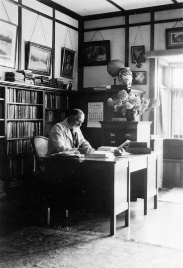 Image: Algernon Charles Gifford sitting in his library at home, Chatsworth Road, Silverstream