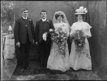 Image: Unidentified wedding group, probably Christchurch district, showing bride and groom, groomsman and bridesmaid, with painted backdrop
