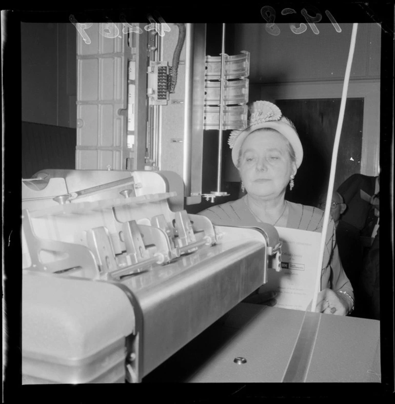 Image: Mabel Howard, Minister of Social Security, inspecting a data processing machine [computer?] built by IBM at the Social Security Building, Wellington