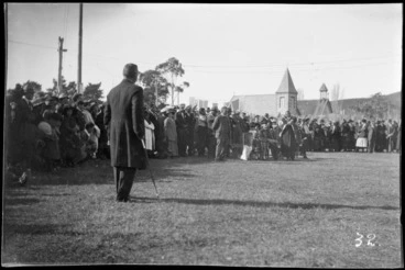 Image: Formal greeting by Maori elder, outside church, Maori clergy with honoured Church Minister, with army officers and crowd looking on, Pakipaki, Hastings, Hawke's Bay District
