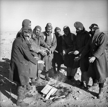 Image: World War II New Zealand soldiers warming their hands by a fire, Western Desert, Egypt