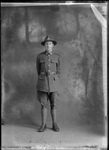Image: Portrait of unidentified soldier, in uniform, with painted studio backdrop, probably Christchurch district