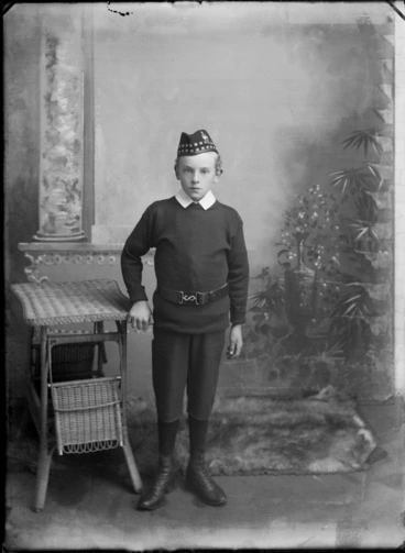 Image: Studio unidentified family portrait, a boy standing wearing a soldier's Glengarry Scottish cap with badge and army belt with a boy's Eton shirt collar, Christchurch