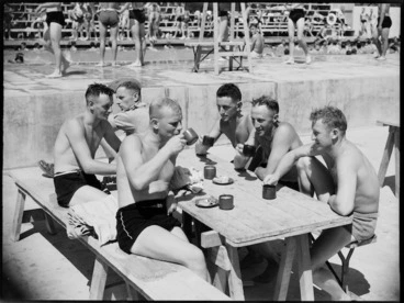Image: Members of 25 NZ Battalion having tea during swimming sports at the Maadi Baths, Egypt, World War II - Photograph taken by G Kaye