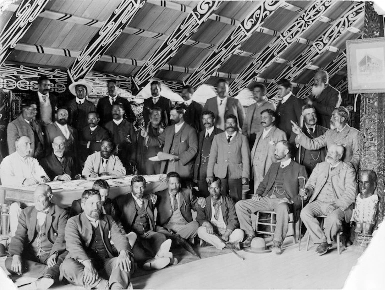 Image: Group of men, possibly at a Land Court meeting, inside Tamatekapua meeting house at Ohinemutu