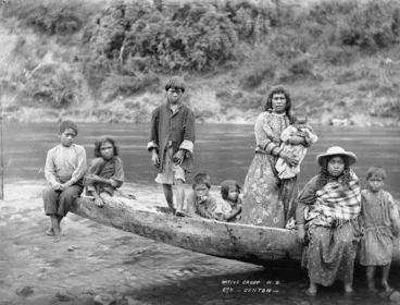 Image: Unidentified group sitting on the prow of a canoe