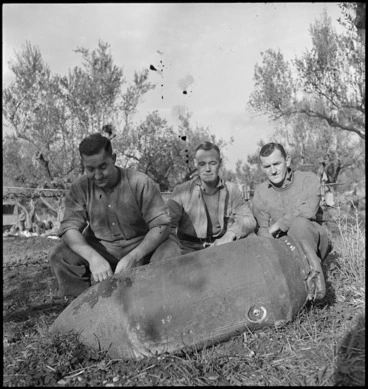 Image: Three NZ soldiers with unexploded bomb that rolled away from house they occupied in Italy, World War II - Photograph taken by George Kaye
