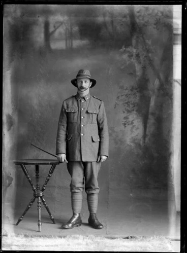 Image: Portrait of unidentified soldier, with a moustache, in uniform, holding a swagger stick, probably Christchurch district